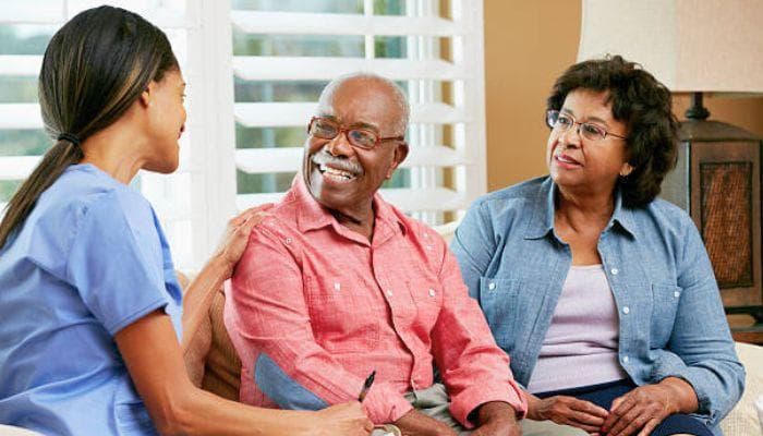 Caregiver speaking with an elderly client